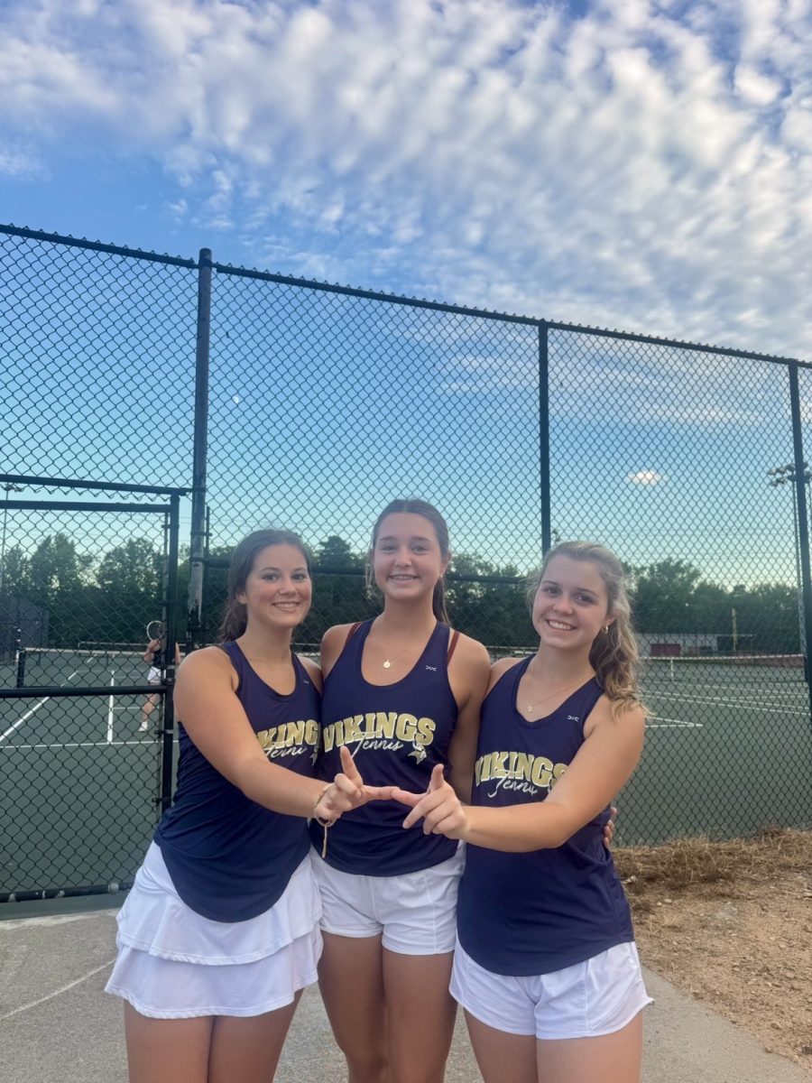Myers Brantley (11), Blythe Lemonds (11) and Susu Wood (11) celebrate after their victory over Wade Hampton High School.
