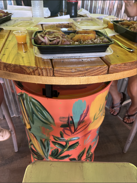 Customers can eat their food on colorful and unique tables at The Roll in Cuban Café.