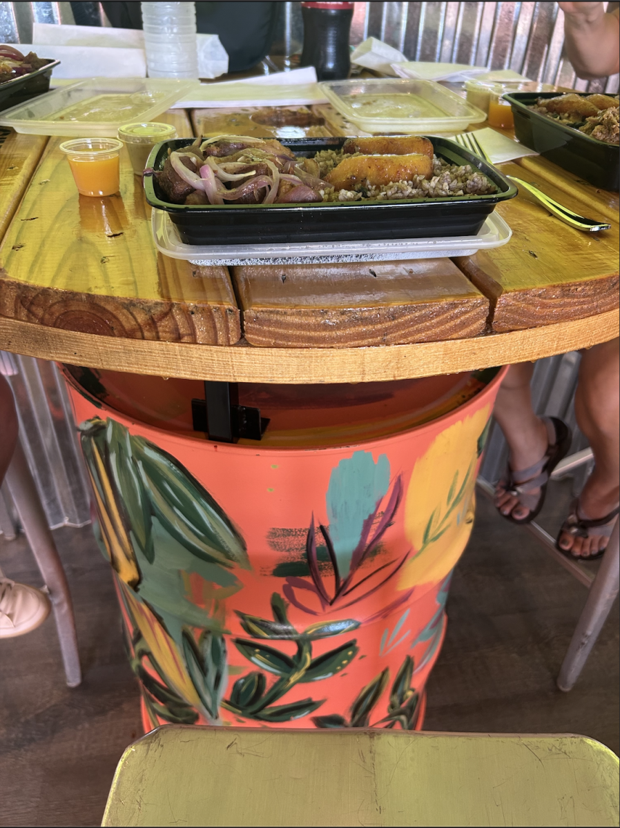 Customers can eat their food on colorful and unique tables at The Roll in Cuban Café.