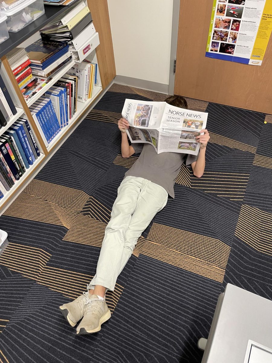 A student lies down on the floor in their free time.