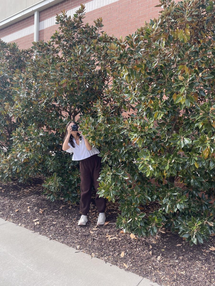A student pretends to be a paparazzo, sneaking to take a shot.