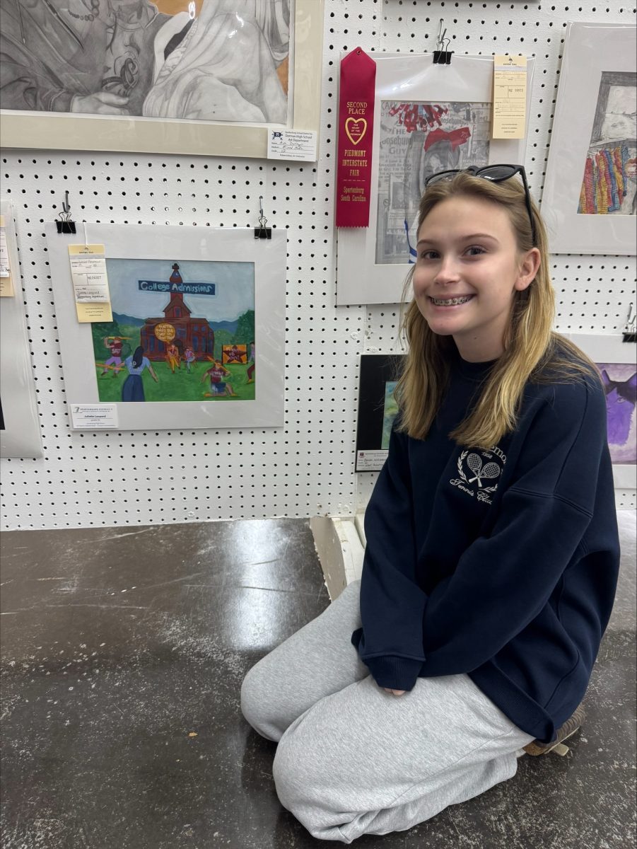 Sophomore Juliette Leopard poses with her artwork at the Piedmont Interstate Fair.
