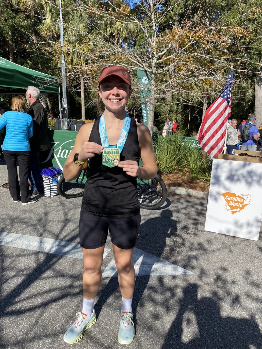History teacher Mallory Mullen displays her medal after running a half-marathon.