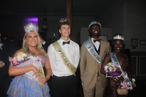 The prom queen, king, princess and prince gather together to take a commemorating photo.